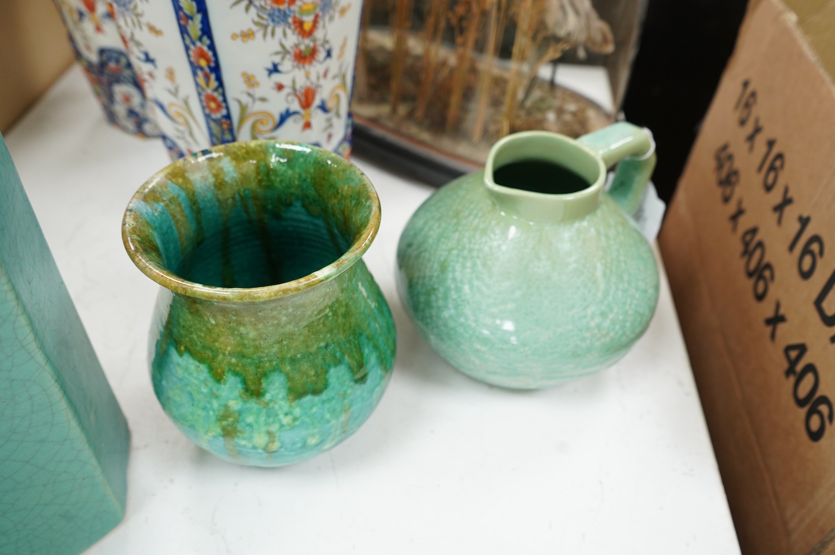 A group of Continental green glazed earthenware vessels including a crystal glazed jug, largest 29cm high